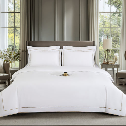 Neatly made bed with white bedding in a well-lit bedroom